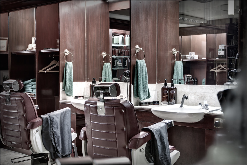 Interior of a modern barbershop with barber chairs and stations
