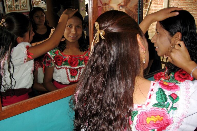Beauty school students practicing hair styling together