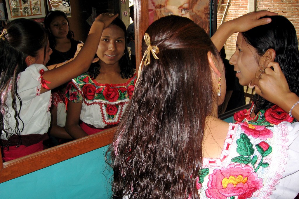 Beauty school students practicing hair styling together