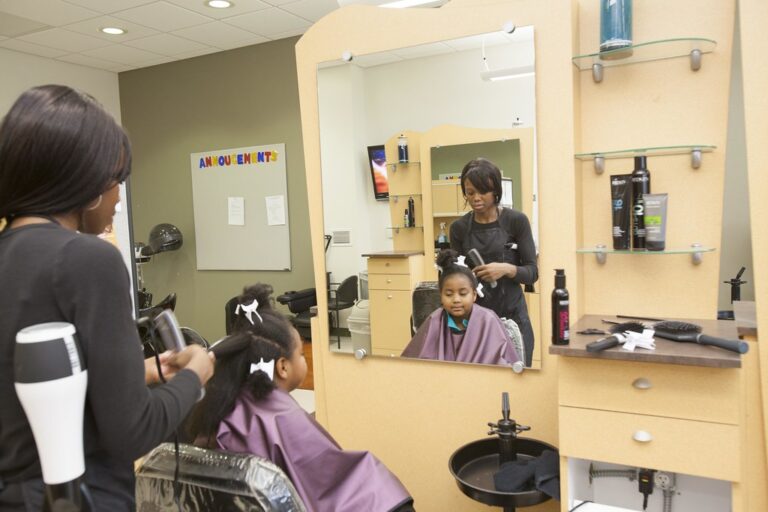 Cosmetology students training in a beauty school salon classroom
