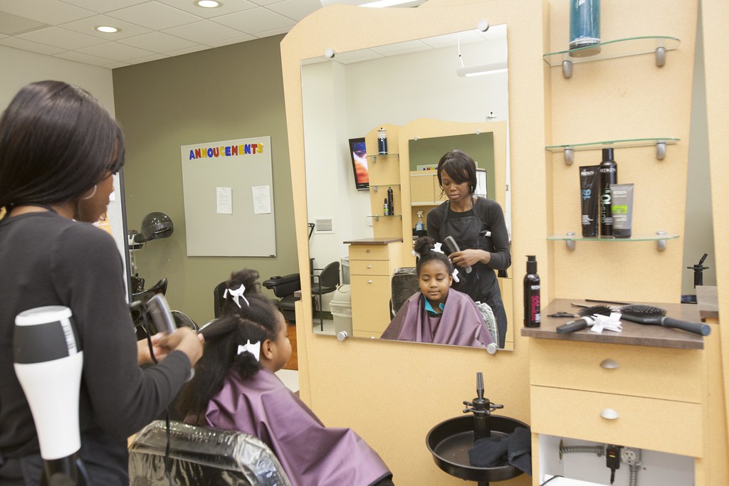 Cosmetology students training in a beauty school salon classroom