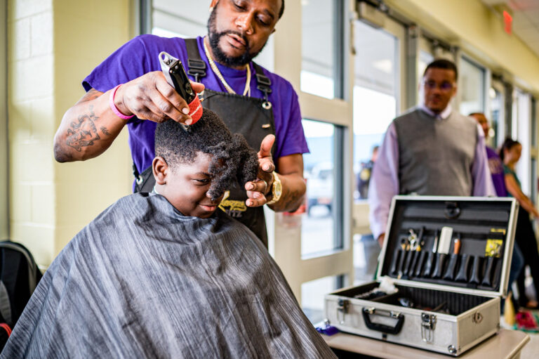 Professional barber cutting a client’s hair in a barbershop